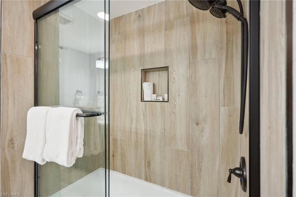 Full bathroom with enclosed tub / shower combo