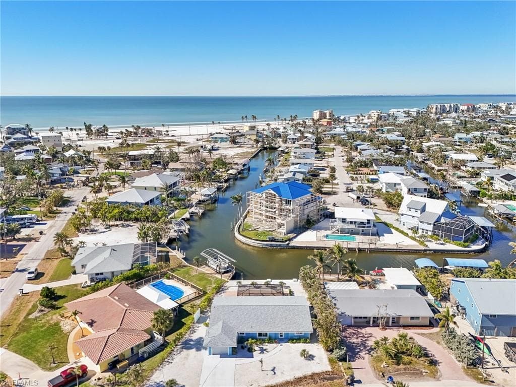 Aerial view of residential area featuring a large body of water
