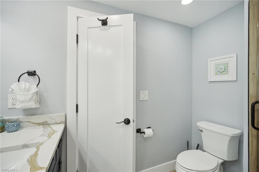 Bathroom with vanity and recessed lighting