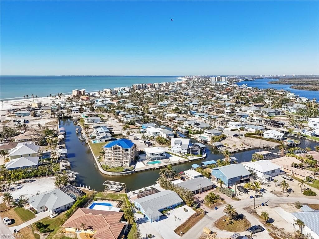 Aerial view of residential area featuring a large body of water