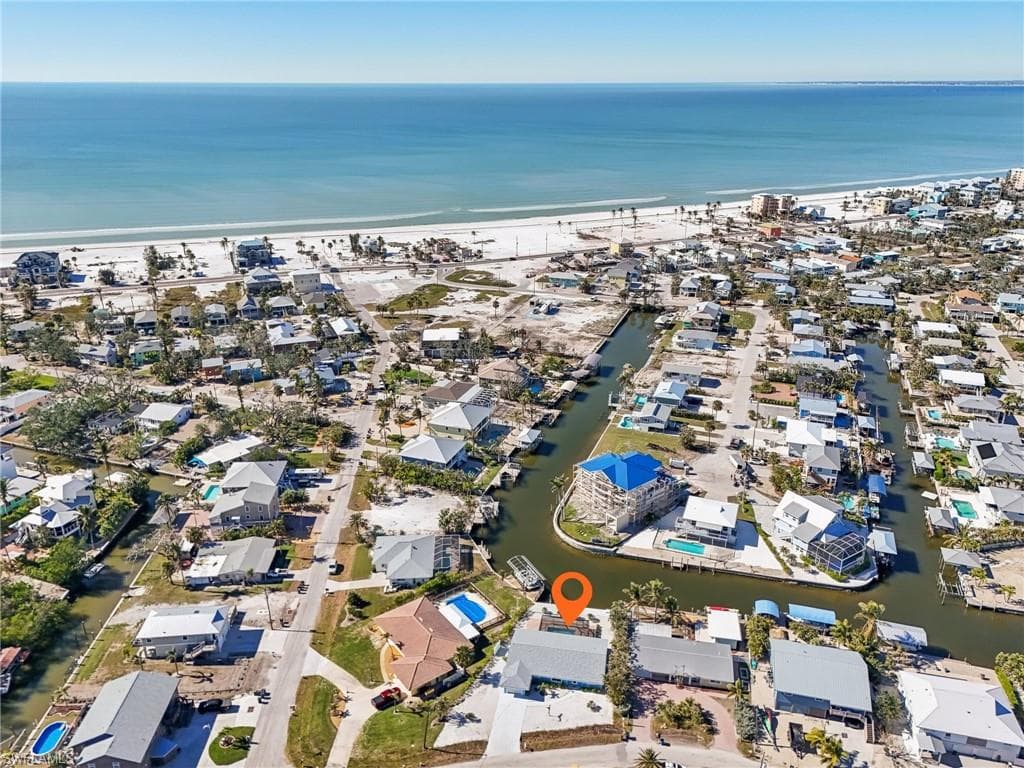 Aerial view of property's location featuring a large body of water and nearby suburban area
