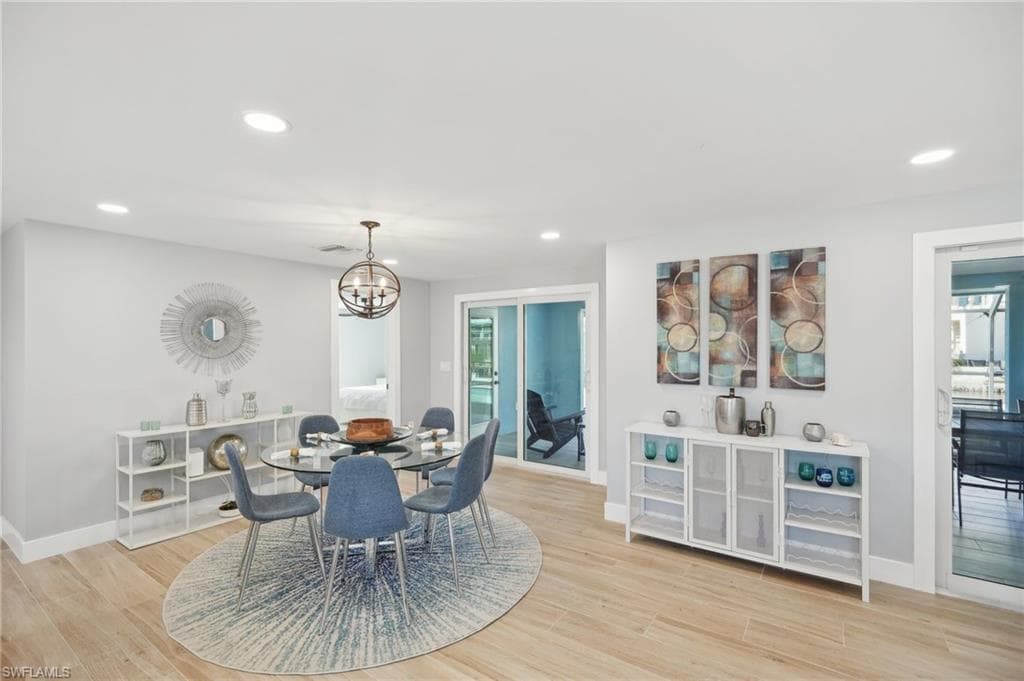 Dining area with recessed lighting, light wood-type flooring, a chandelier, and healthy amount of natural light