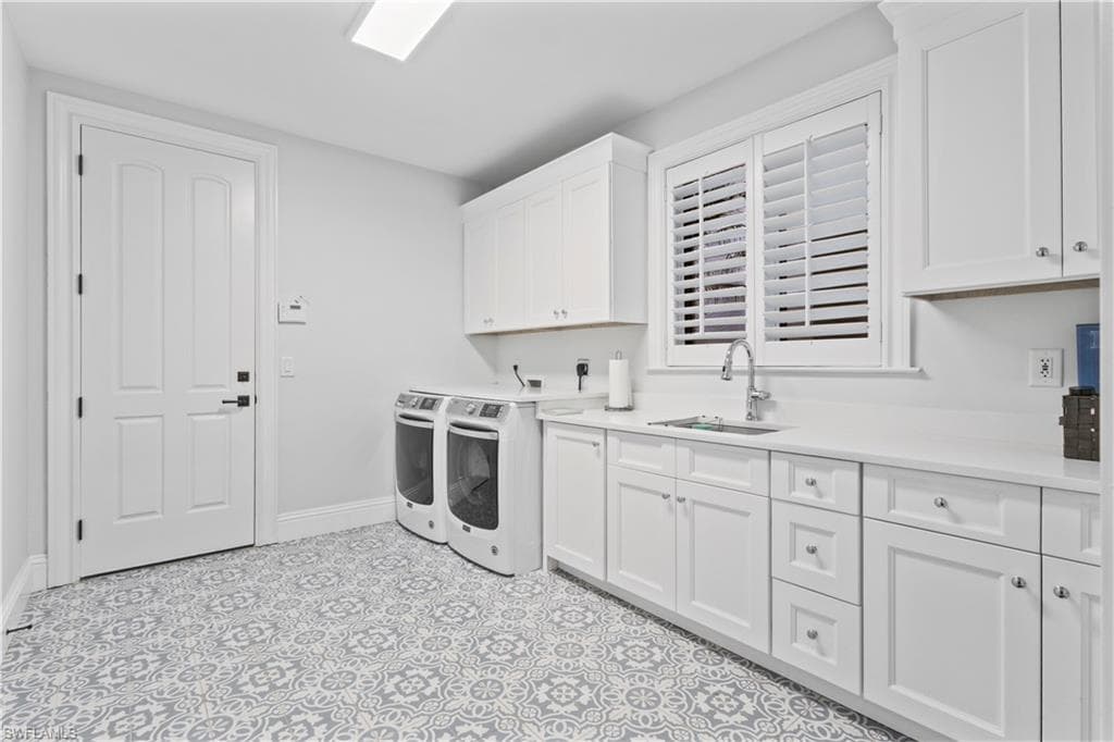 Washroom featuring washing machine and dryer and cabinet space