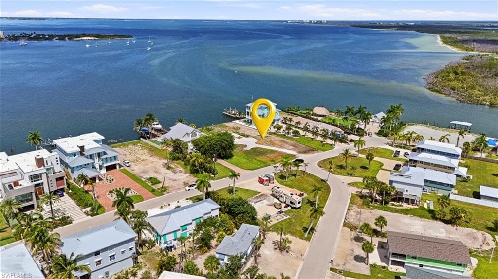 Waterfront property featuring direct - Virtually Edited Imageaccess to open water, a developed residential area, and a paved street