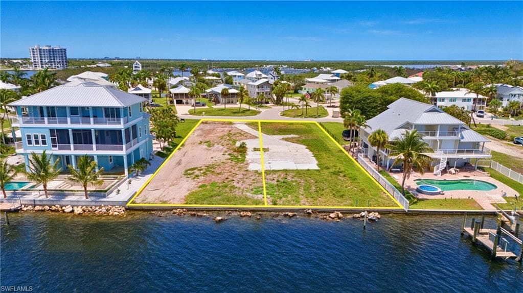 Waterfront lot featuring a partially cleared building site and direct water access- Virtually Edited Image