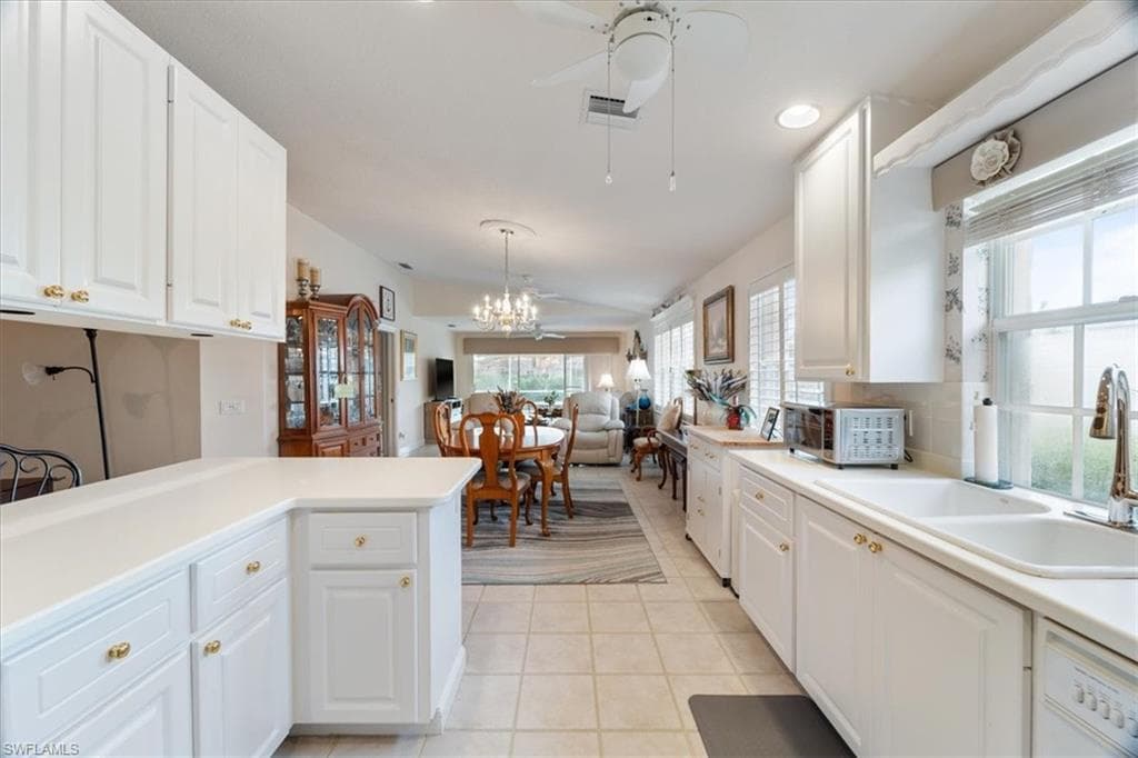 Kitchen with white cabinetry, light countertops, ceiling fan, light tile patterned flooring, and recessed lighting
