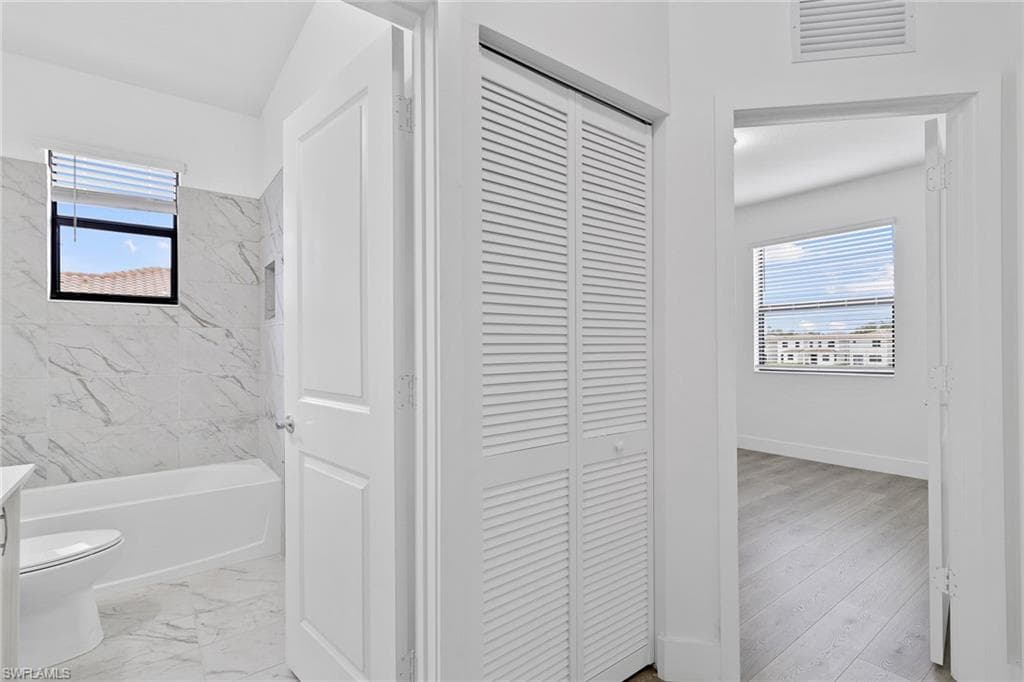 Full bathroom with vanity, and washtub / shower combination