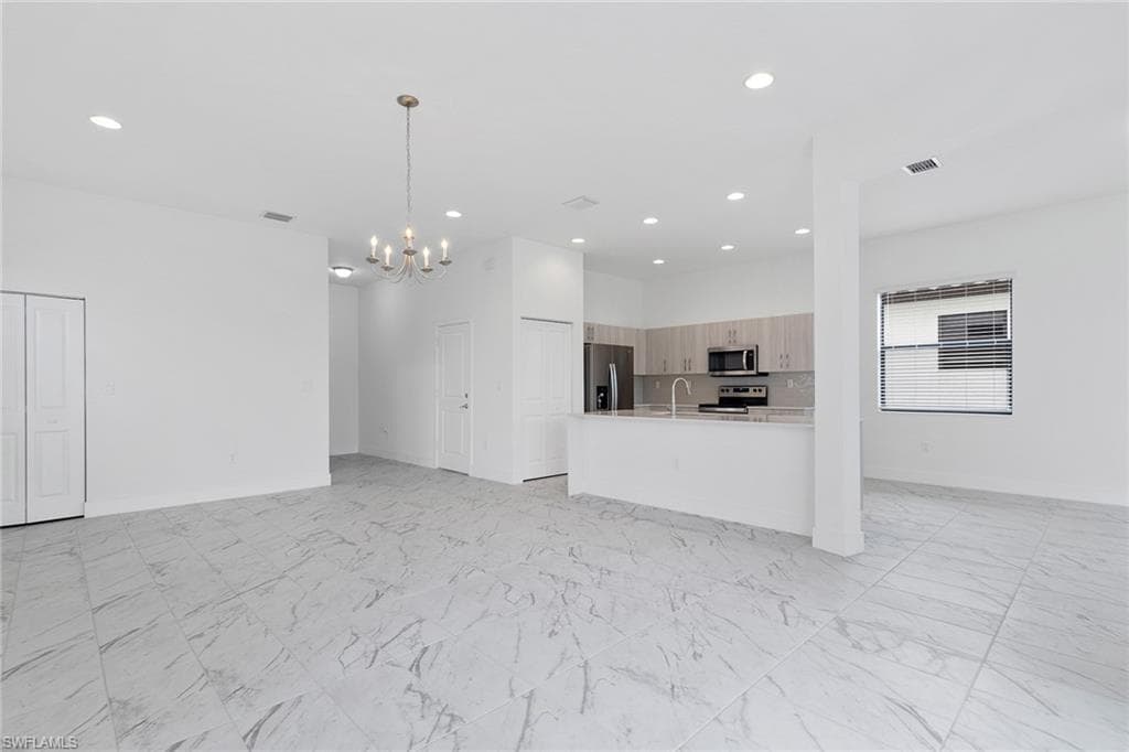 Different angle of living room featuring tile flooring, and recessed lighting.