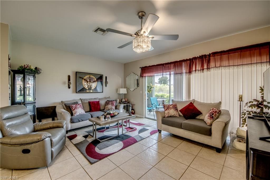 Living area with light tile patterned flooring and a ceiling fan