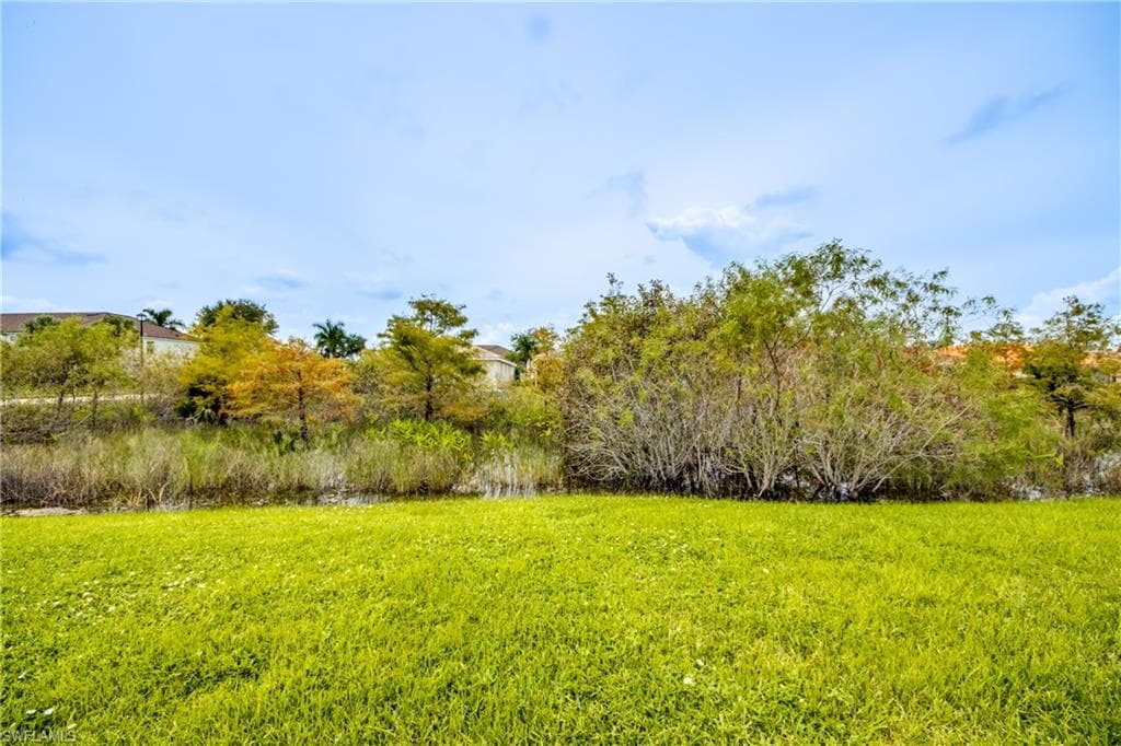 View of green lawn with a water view