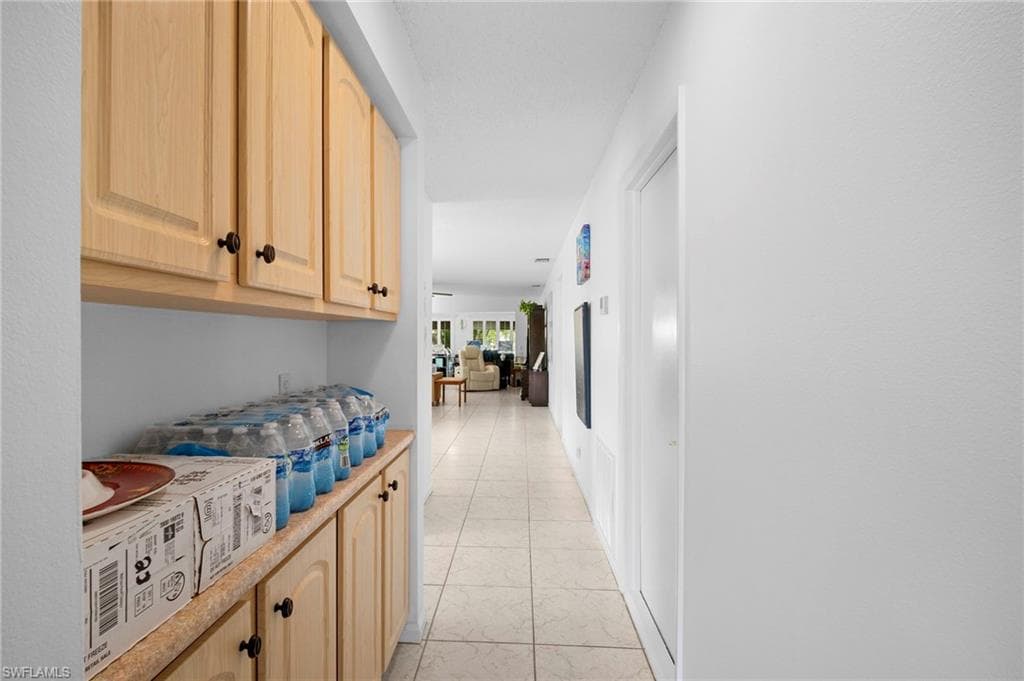 Hallway to 2nd Bedroom showing extra cabinetry off Kitchen