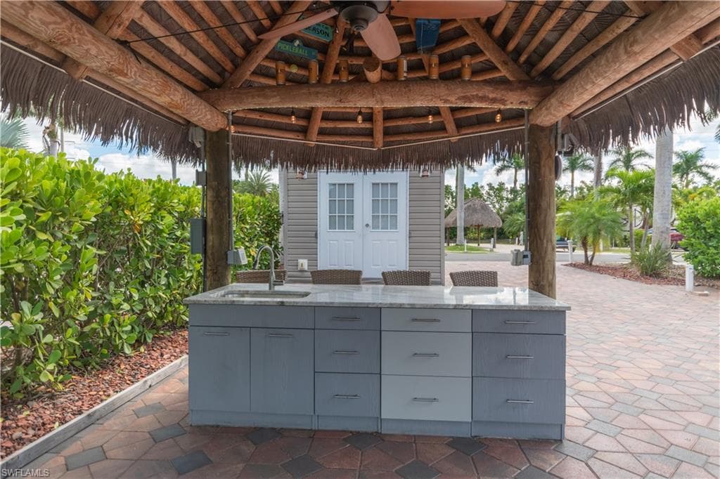View of patio with a gazebo, ceiling fan, and mail area