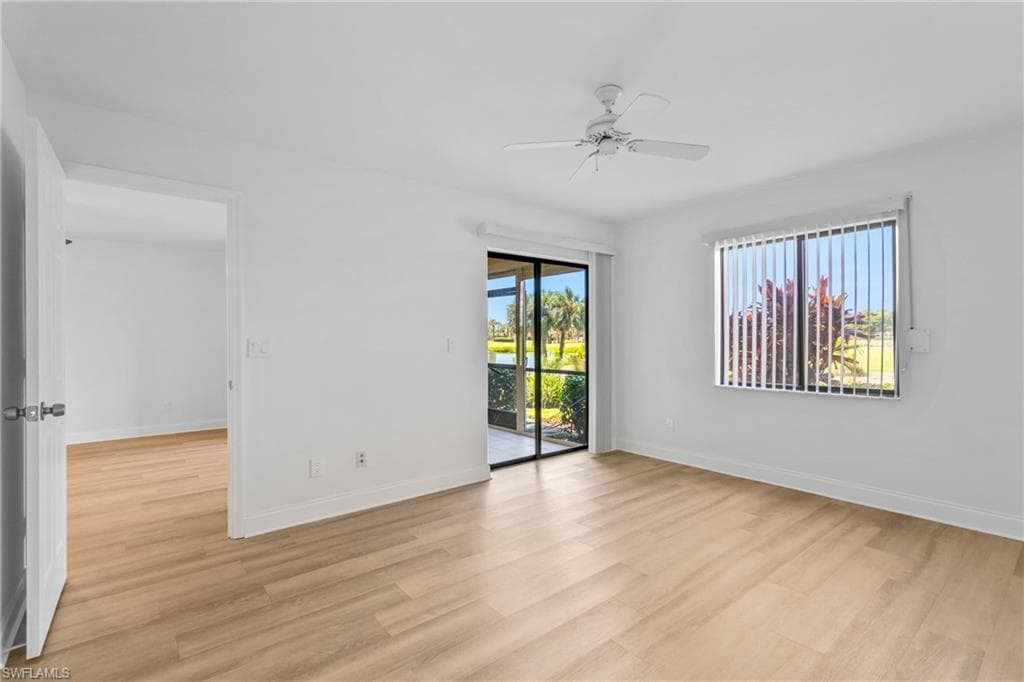 Unfurnished room with light wood finished floors, healthy amount of natural light, and ceiling fan
