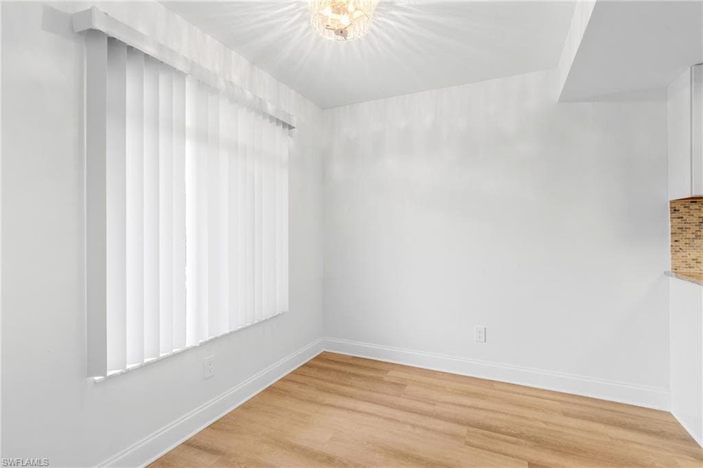 Unfurnished room featuring light wood-style flooring and baseboards