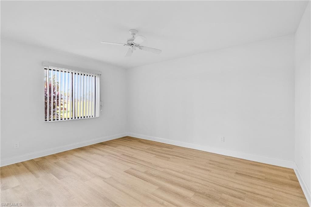 Empty room with light wood-type flooring and a ceiling fan