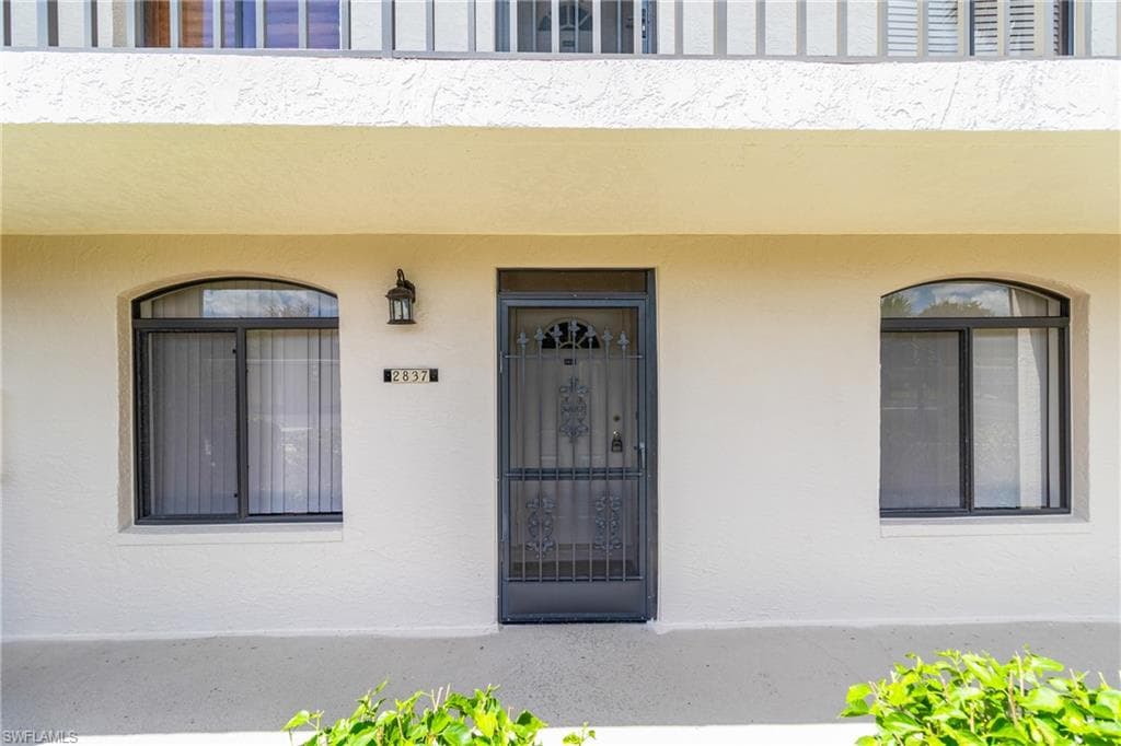 Property entrance with stucco siding
