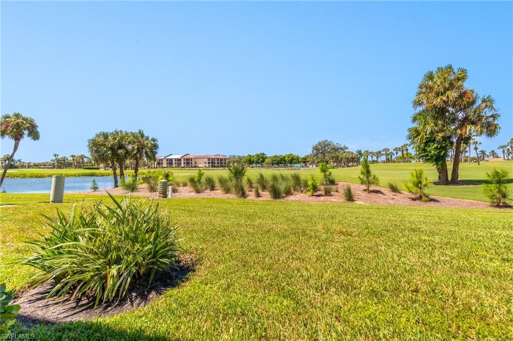 View of green lawn featuring a water view
