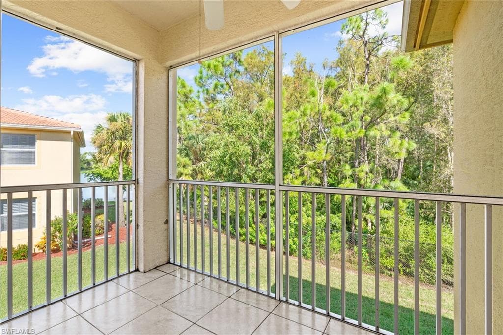 Balcony featuring a sunroom and a ceiling fan
