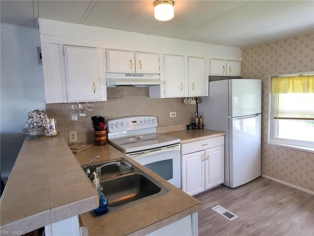Updated kitchen with new flooring.