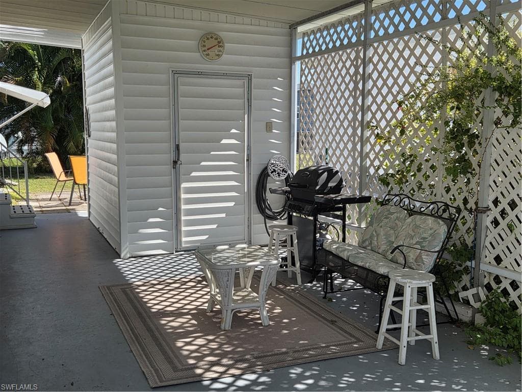 Carport with shed for extra storage.