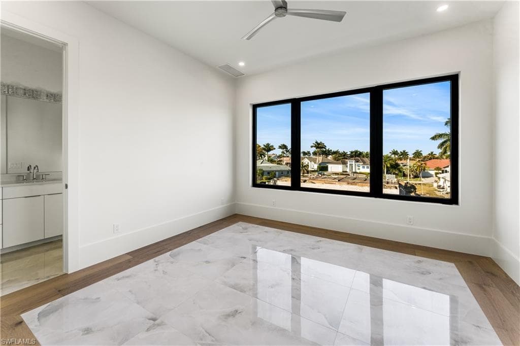 Spare room with light wood-style flooring, ceiling fan, and recessed lighting