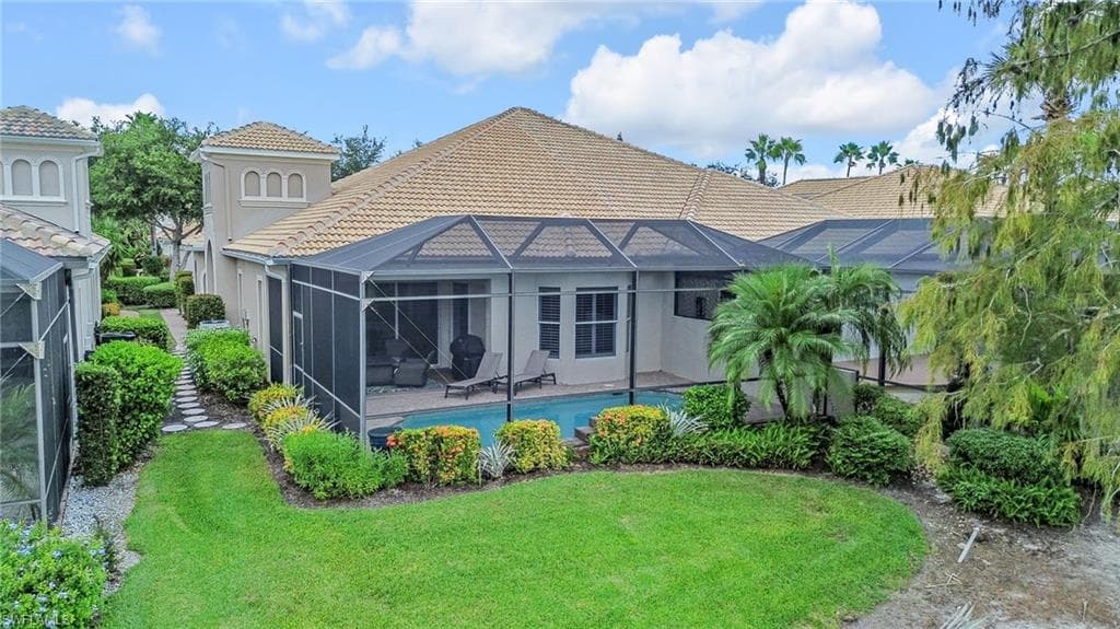 Back of property featuring lanai, newer tile roof, dining area, pool with the only unobstructed view on Santorini.