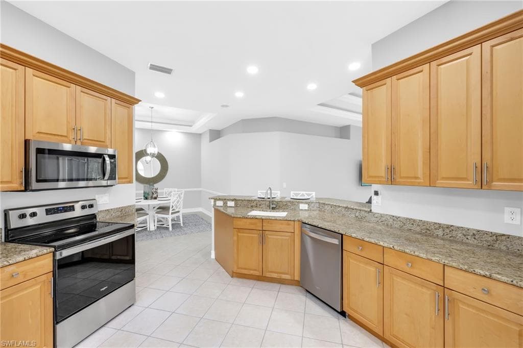 Kitchen featuring new stainless steel appliances, new recessed lighting throughout, stone countertops, new stainless steel knobs on cabinets