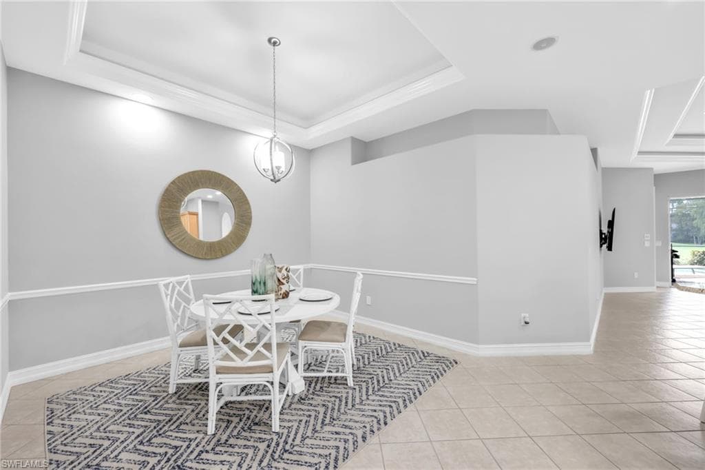 Bright, light, airy Large Dining/Den space featuring a raised ceiling, light tile patterned flooring, and recessed lighting.