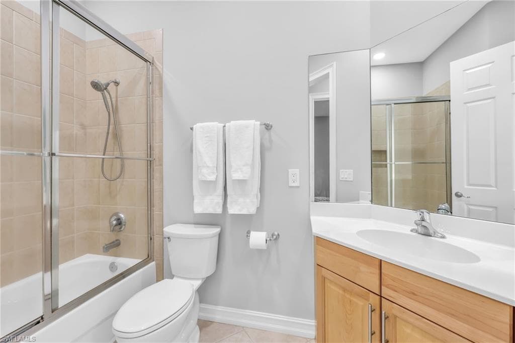 Full hall bath with shower/tub combination with glass door, vanity.
