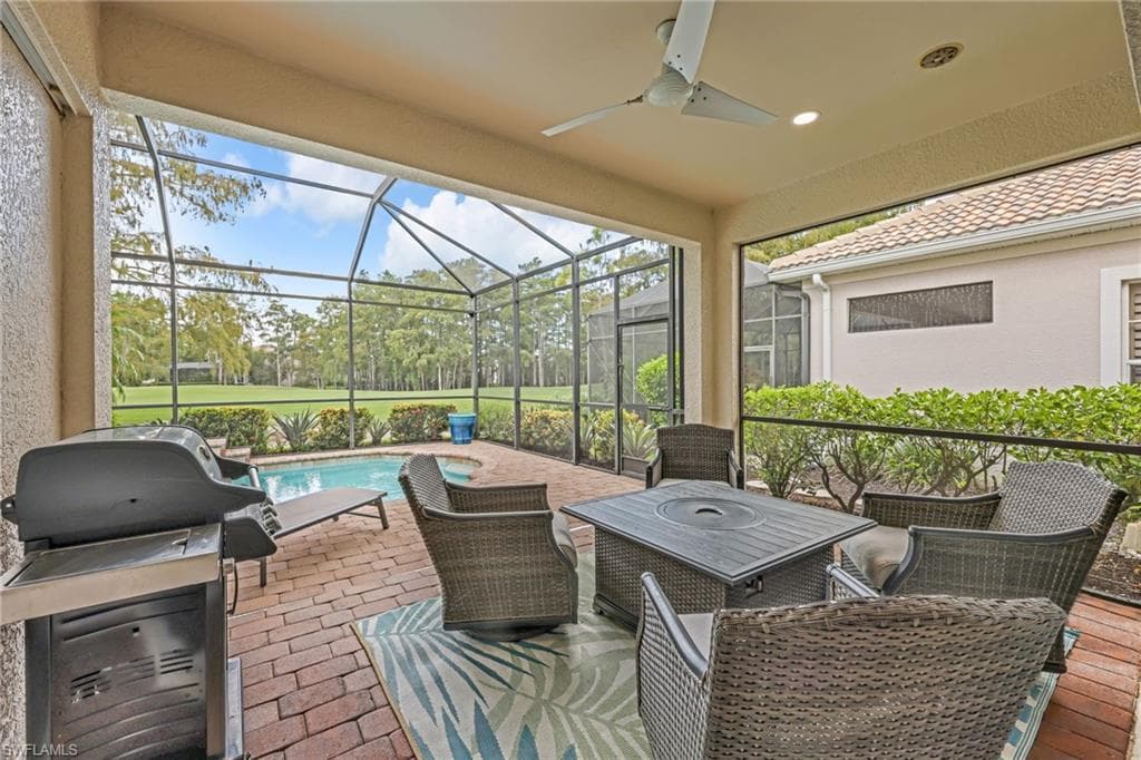 View of patio with views of golf course, entertaining, lounging area, grilling area, lanai, pool, ceiling fan, high hat lighting