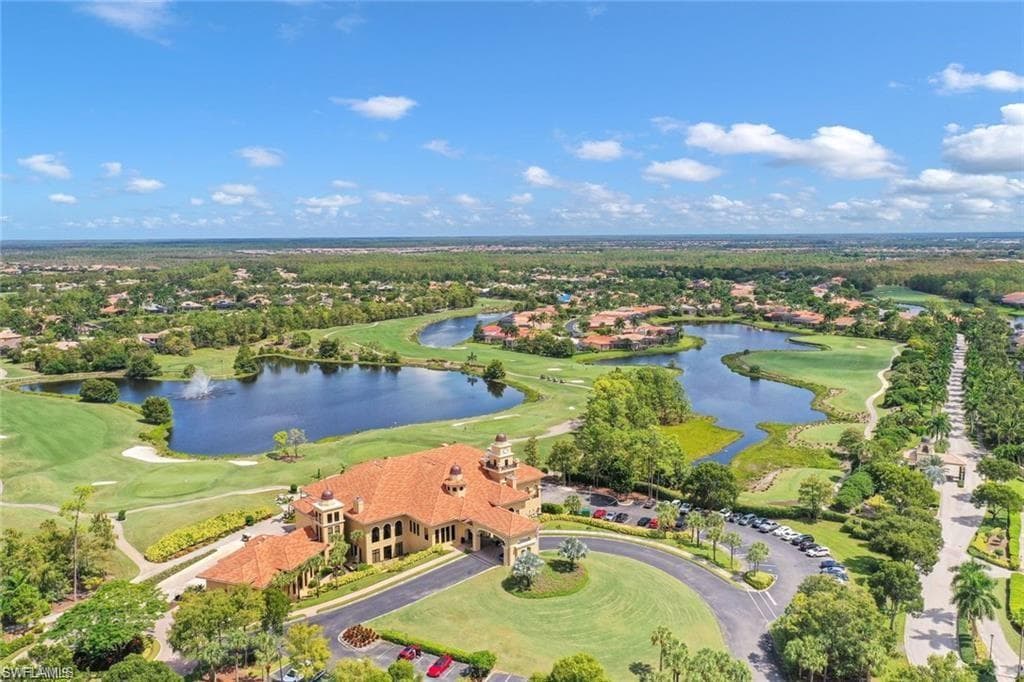 Aerial perspective of clubhouse area featuring golf course and lakes