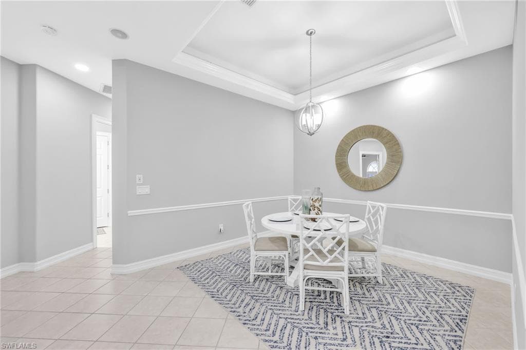 Bright, light, airy Large Dining/Den space featuring a raised ceiling, light tile patterned flooring, and recessed lighting.