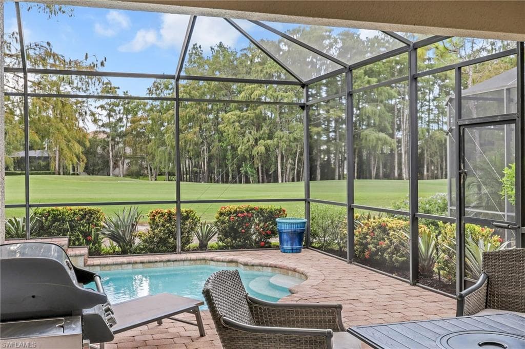 View of unobstructed golf course, patio sitting/dining area, grill, new screened lanai, pool, ceiling fan and high-hat lighting