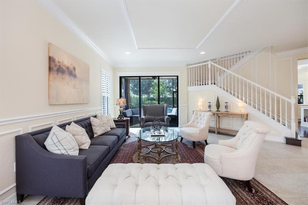 Tiled living room with a raised ceiling and crown molding