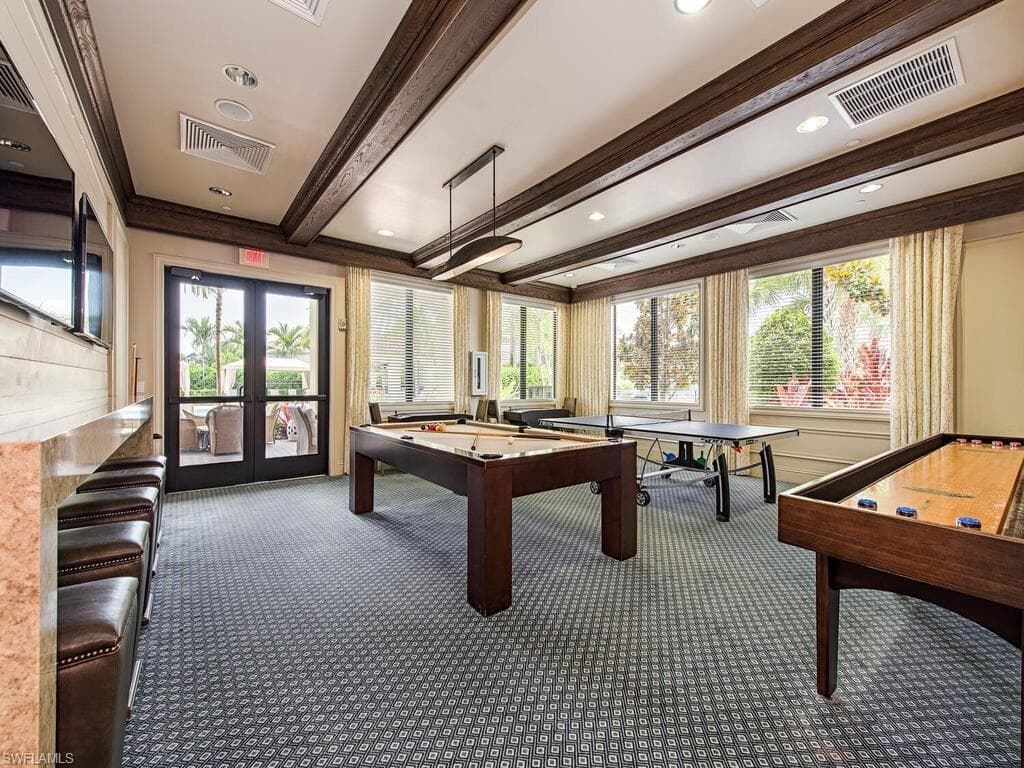 Game room with billiards, french doors, beamed ceiling, crown molding, and dark carpet