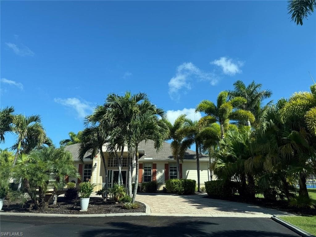 View of building exterior featuring decorative driveway