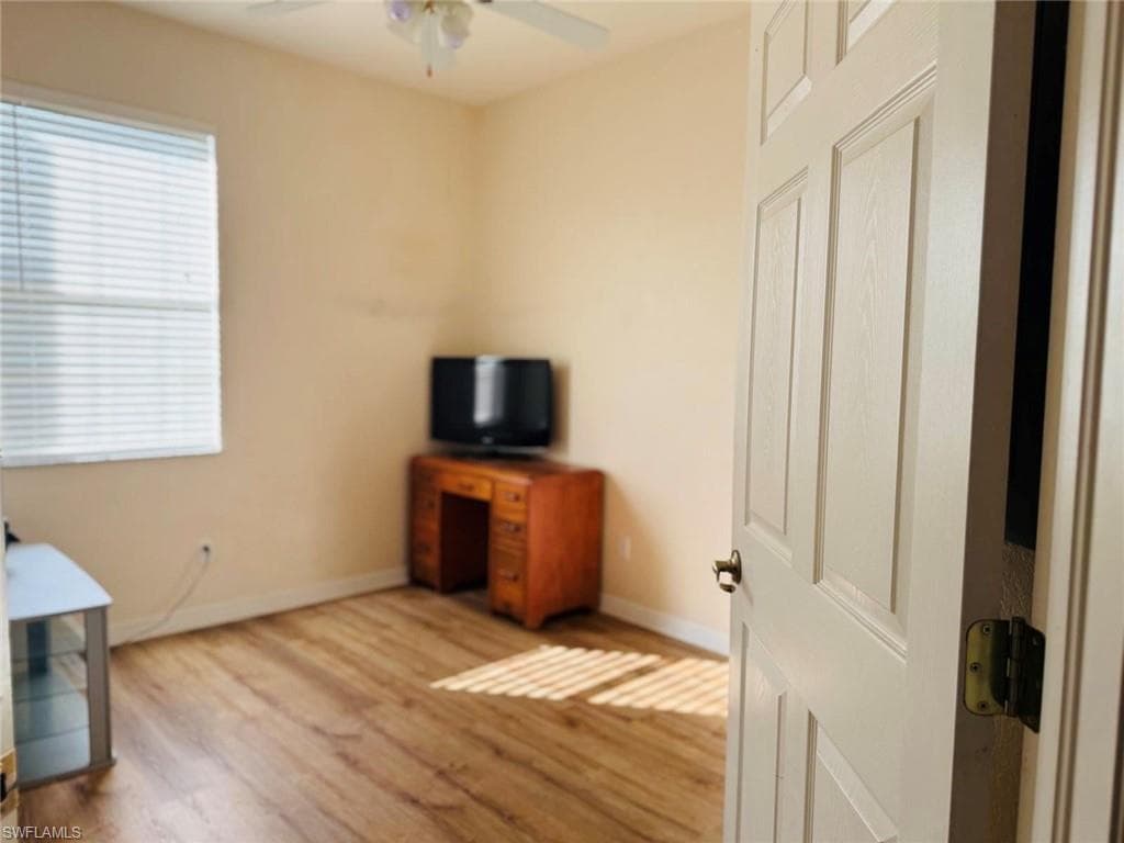Unfurnished office with wood finished floors and ceiling fan