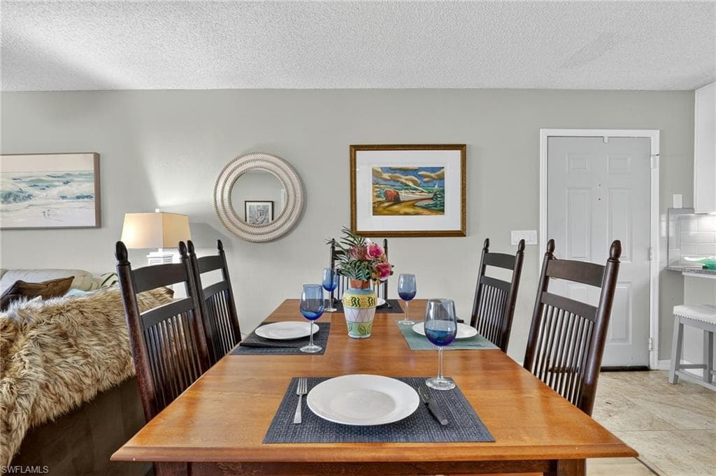 Dining area featuring a textured ceiling