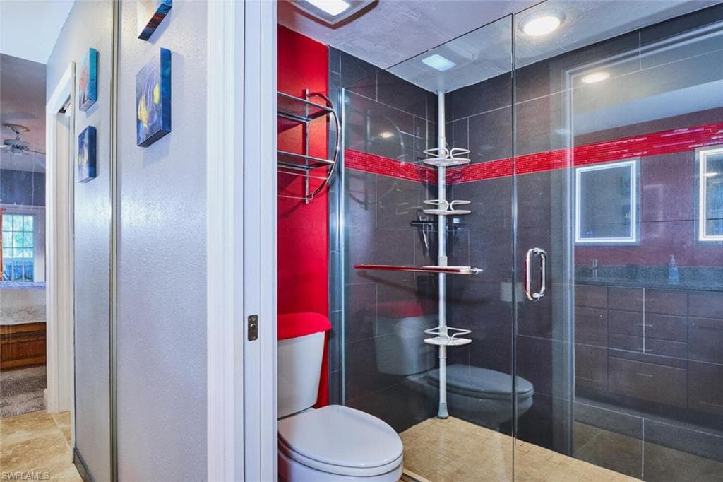 Bathroom featuring toilet and a shower stall