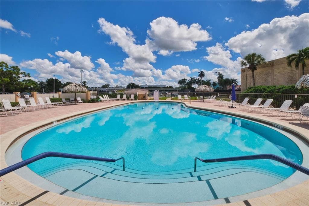 Community pool featuring a patio
