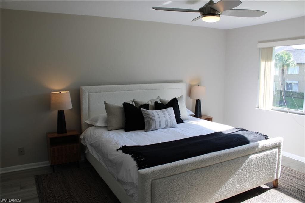Bedroom featuring wood finished floors and a ceiling fan