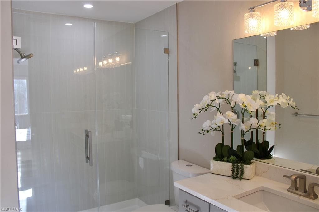 Full bath with a stall shower and vanity