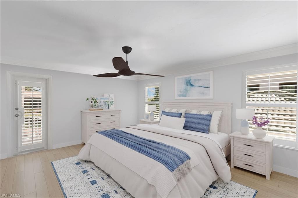 Virtually Staged - Bedroom with light wood-style floors, crown molding, and ceiling fan