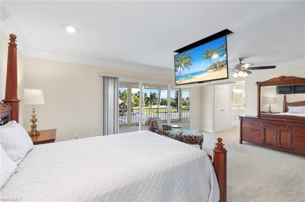 Bedroom featuring crown molding, access to exterior, light carpet, and ensuite bathroom