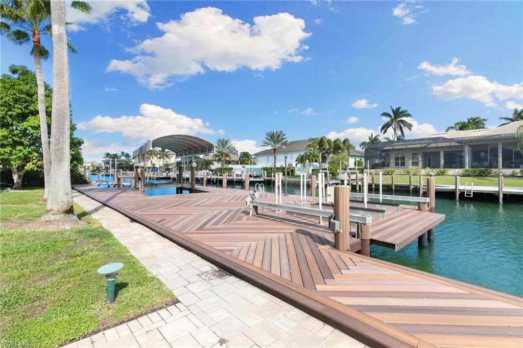 Dock area featuring boat lift and a water view