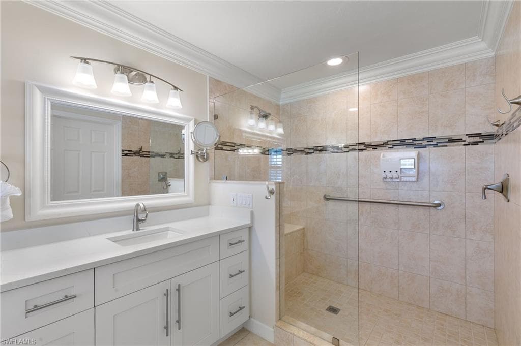 Full bathroom with vanity, crown molding, a walk in shower, and recessed lighting