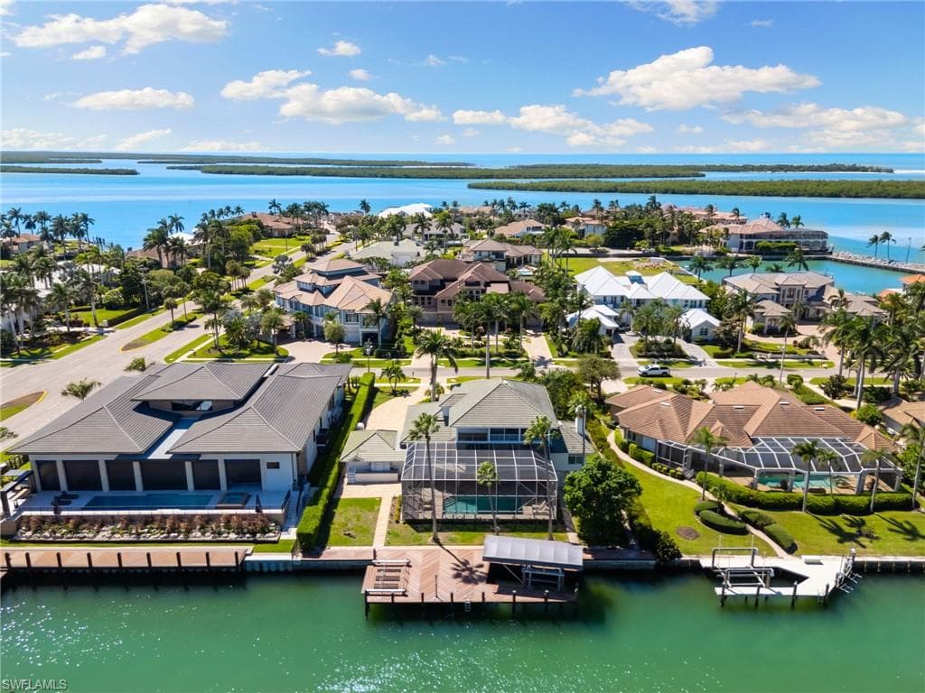 Aerial view of residential area featuring a nearby body of water
