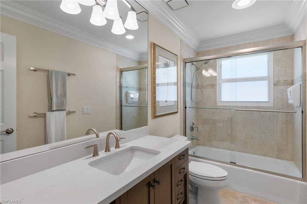 Full bath featuring combined bath / shower with glass door, vanity, crown molding, recessed lighting, and tile patterned flooring