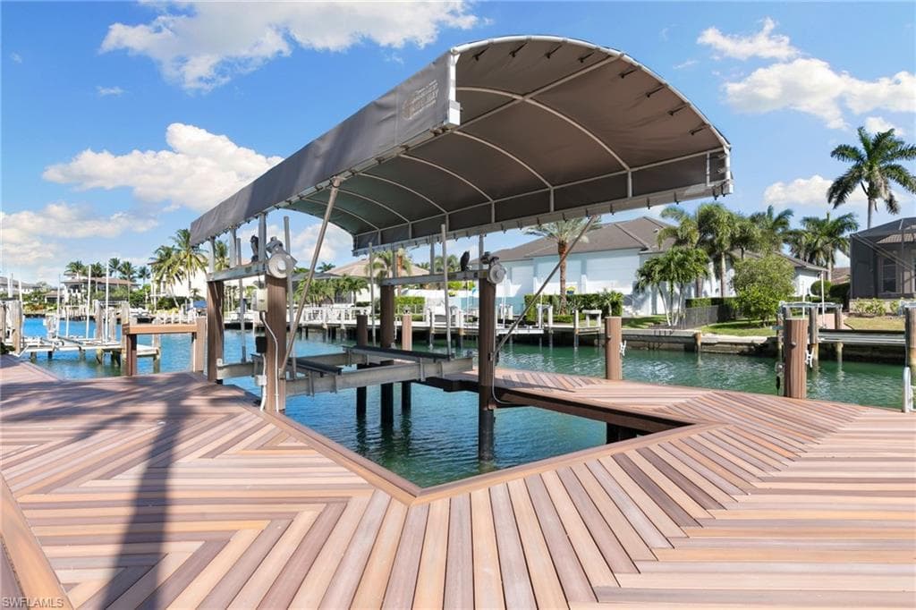 Dock featuring boat lift and a water view