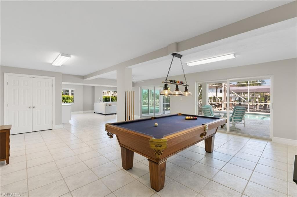 Playroom featuring light tile patterned floors, plenty of natural light, and billiards table